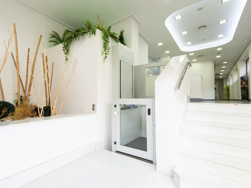 Entrada de Clínica Dental Carmona en Totana, con la escalera y la plataforma elevadora